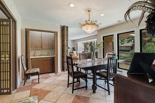 Dining area with a chandelier, ornamental molding, recessed lighting, light tile patterned floors, and french doors | Image 5