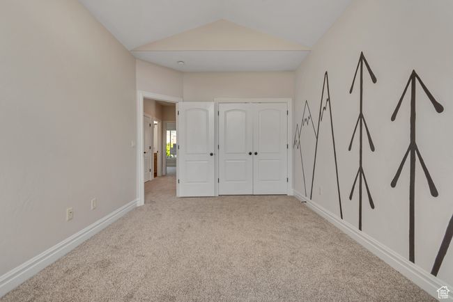 Unfurnished bedroom with light carpet and vaulted ceiling | Image 21