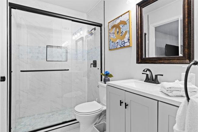 Bathroom featuring toilet, a stall shower, and vanity | Image 29