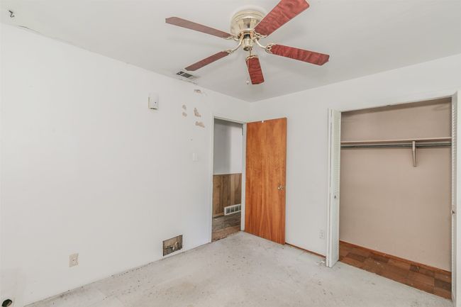 Unfurnished bedroom with a closet and a ceiling fan | Image 23