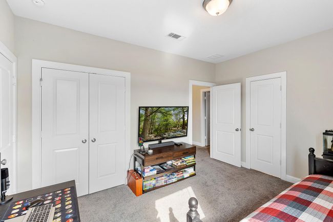 One of four spacious bedrooms, offering flexibility for family, guests, or a home office. | Image 39