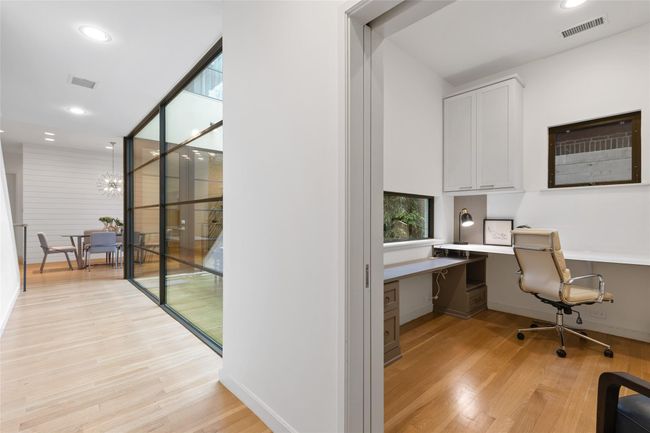 Home office featuring built in desk, light wood-style floors, recessed lighting, a chandelier, and baseboards | Image 28