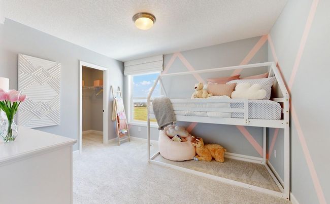 (Photo of a decorated model, actual homes finishes will vary) The third generously sized upper level secondary bedroom with a spacious closet. | Image 19