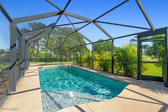 Outdoor pool with a lanai and a patio area | Image 18
