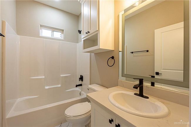 Full bathroom with shower combination, vanity, and toilet | Image 14