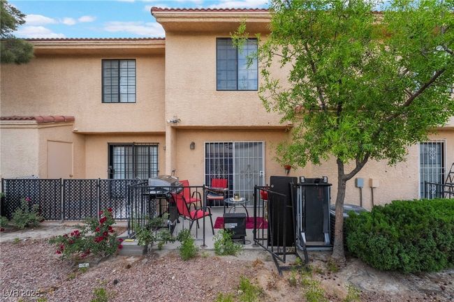 Rear view of property with stucco siding and a patio area | Image 38