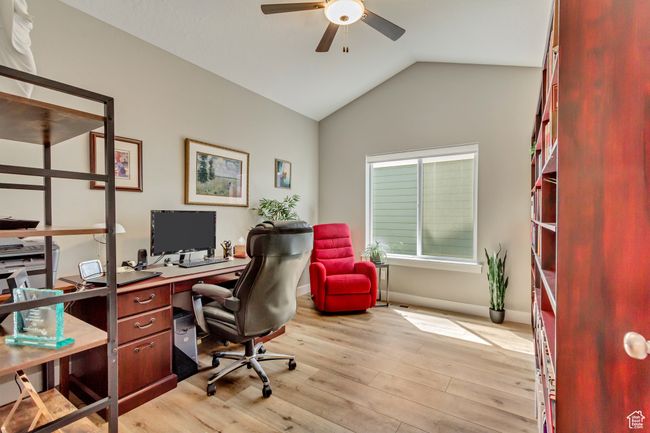 Office area featuring lofted ceiling, baseboards, light wood-style floors, and ceiling fan | Image 21