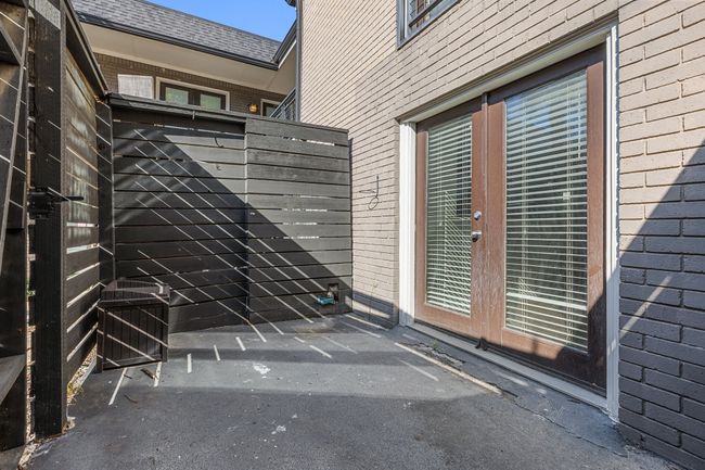 Entrance to property with roof with shingles, a patio, brick siding, and fence | Image 22