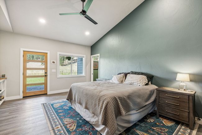 Bedroom featuring wood finished floors, vaulted ceiling, recessed lighting, baseboards, and ceiling fan | Image 23