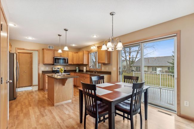 The kitchen and dining areas have quality laminate flooring that can handle plenty of wear and tear. This space is really open. | Image 4