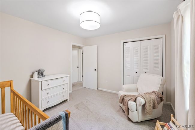 Bedroom with baseboards, light carpet, and a closet | Image 15
