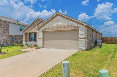 View of front of property featuring a front yard and a garage | Image 3