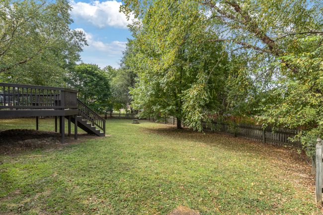 Fenced backyard with mature trees | Image 26