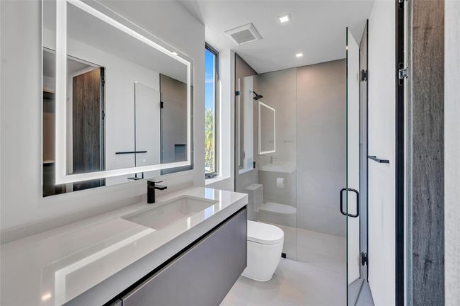 Bedroom 2 En Suite Bath with Custom Mirror and Pedini Cabinetry | Image 51