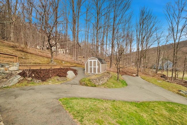View of yard with an outbuilding, driveway, and a shed | Image 22