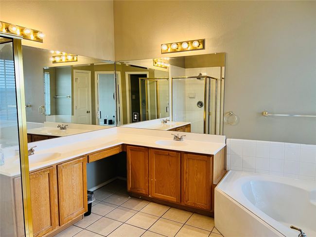 Master Bathroom featuring tile patterned floors, independent shower and bath, and vanity | Image 16