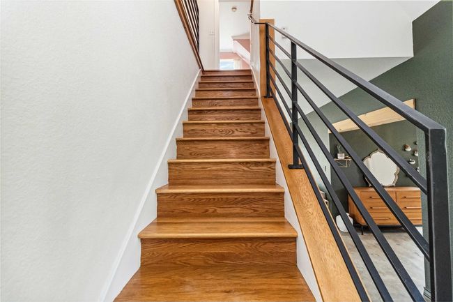 Stairway featuring wood finished floors | Image 19