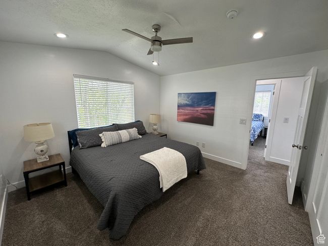 Carpeted bedroom featuring vaulted ceiling, baseboards, recessed lighting, and a ceiling fan | Image 21
