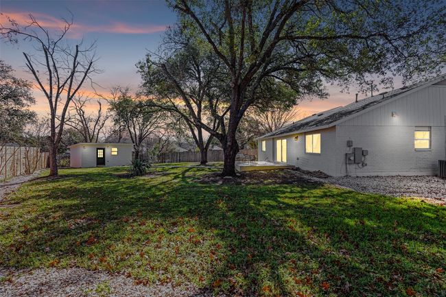 Yard at dusk featuring an outbuilding and cooling unit | Image 31