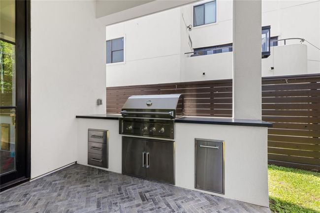 Stainless steel drawers, trash receptacle, gas grill, granite countertops for prep. | Image 48