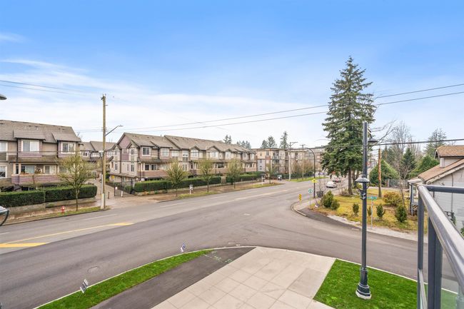 View of asphalt street with a residential view, street lighting, curbs, and sidewalks | Image 19