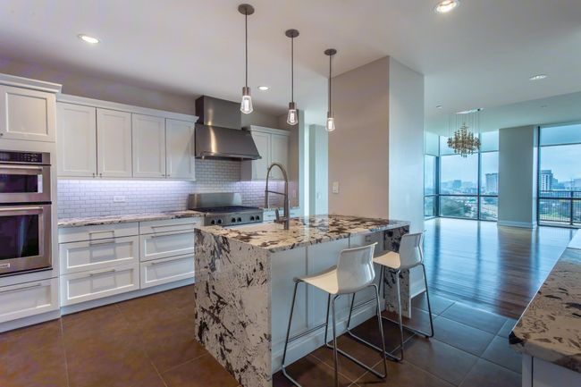 Newly updated kitchen has breakfast bar & pendant lighting. | Image 17