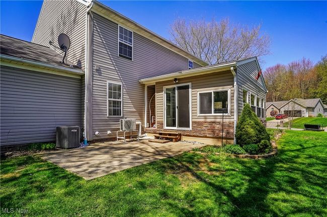 Back of property featuring central AC unit, a patio area, a yard, and entry steps | Image 43