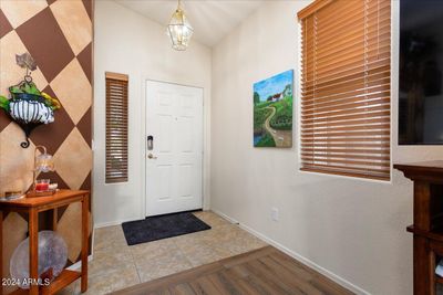 The front entry into the great room. The house has updated lighting and ceiling fans throughout. The living room and all bedrooms have updated wood look vinyl flooring. | Image 3