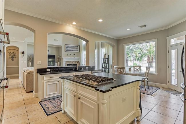 Enjoy stunning backyard views from the kitchen, enhanced by ample recessed lighting. | Image 11