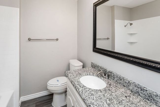 Full bath featuring vanity and wood finished floors | Image 18