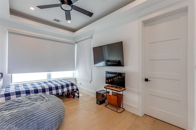 Bedroom featuring a ceiling fan, light wood-style floors, baseboards, and recessed lighting | Image 26