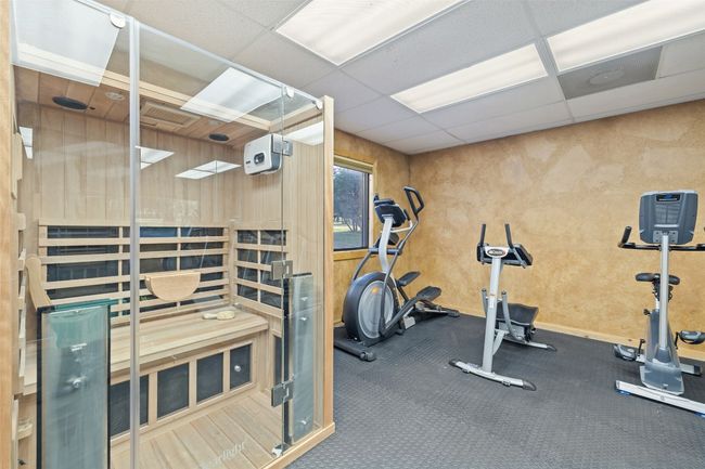 Exercise room featuring a relaxing sauna and a drop ceiling | Image 32