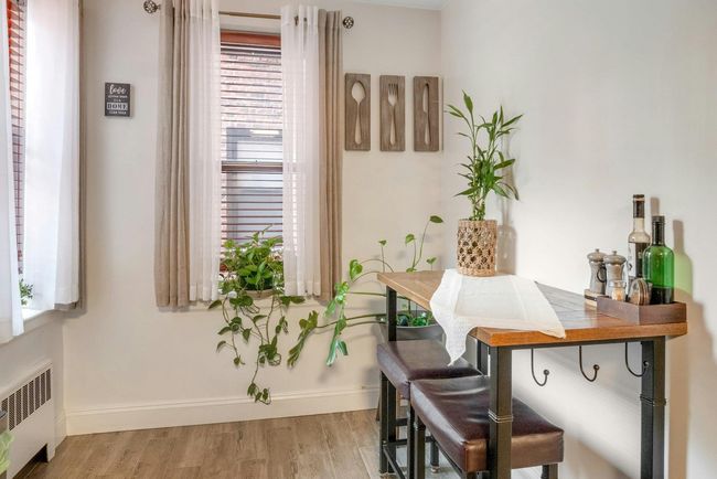 Home office featuring radiator heating unit and wood finished floors | Image 11