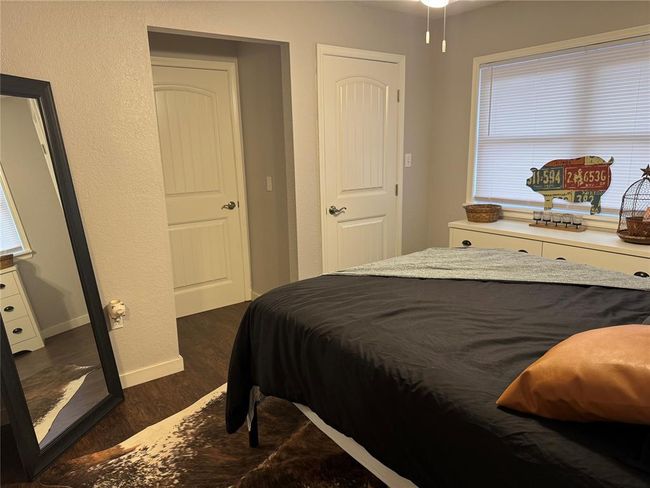 Bedroom with dark wood-type flooring | Image 12