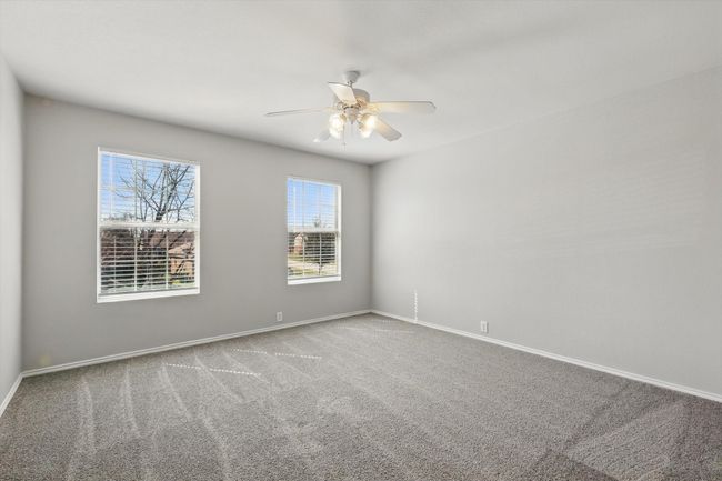 Unfurnished room with a ceiling fan and carpet floors | Image 22