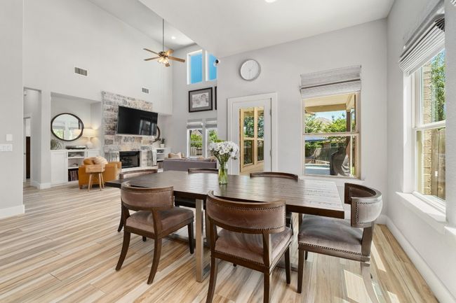 Dining room looking onto the covered patio and living room. | Image 11