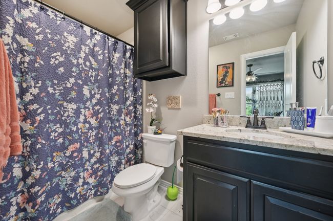 Ensuite bathroom with vanity, tile patterned flooring, and a shower with curtain | Image 15