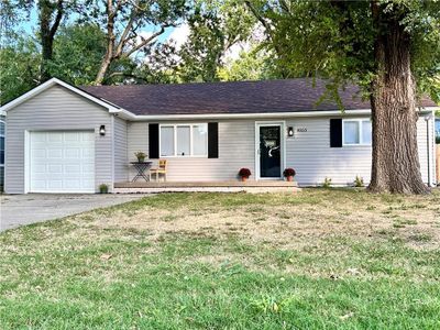 Ranch-style house with a front yard and a garage | Image 2