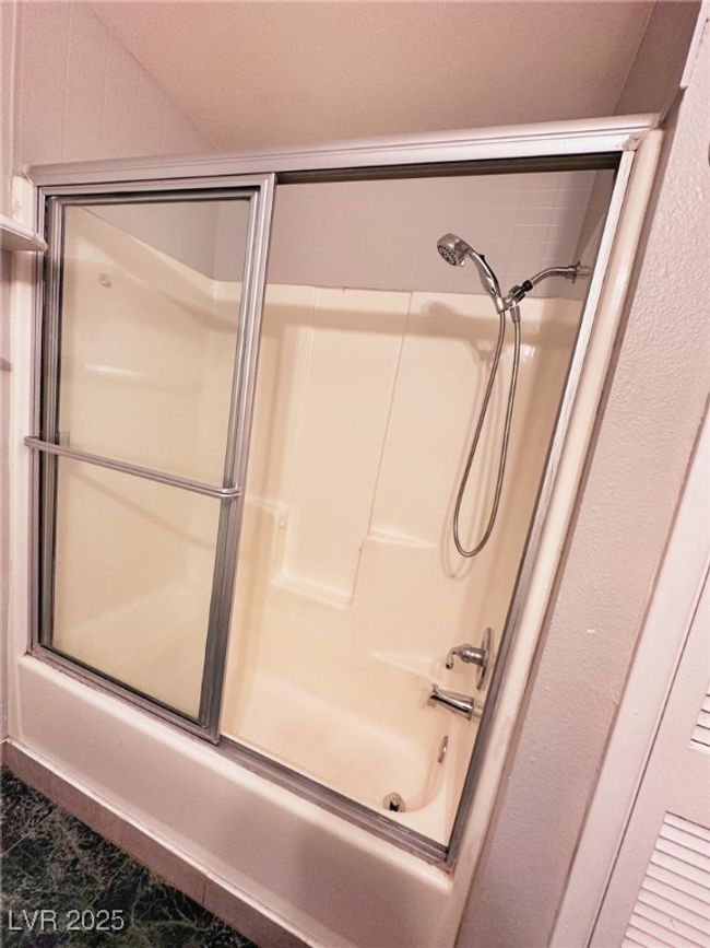 Full bath featuring shower / bath combination with glass door | Image 9