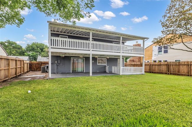View of the back of the house showing the first-floor patio and the second-floor balcony. | Image 26