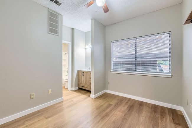 Unfurnished bedroom featuring visible vents, light wood-style floors, baseboards, and a textured ceiling | Image 10