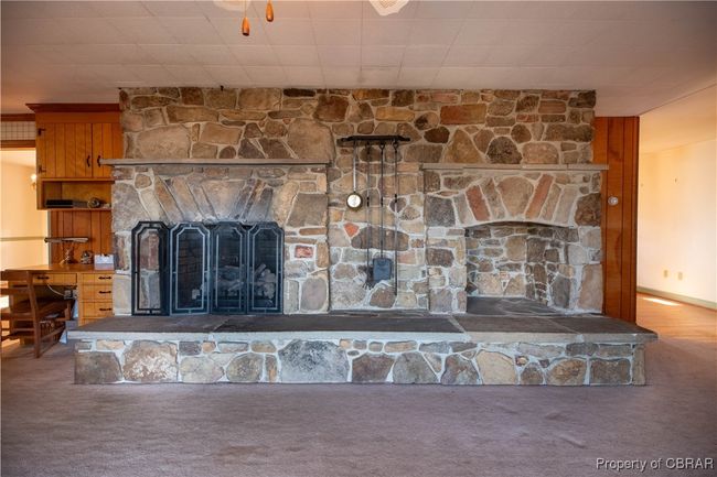 Details with carpet flooring and a stone fireplace | Image 12