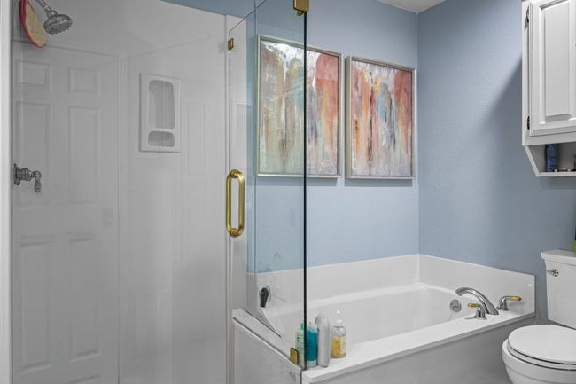 Full bath featuring a shower stall and a bath | Image 17