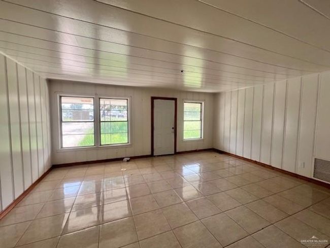 Unfurnished room featuring light tile patterned floors and baseboards | Image 5