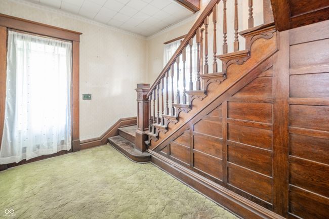 stairs with ornamental molding, baseboards, and carpet floors | Image 4