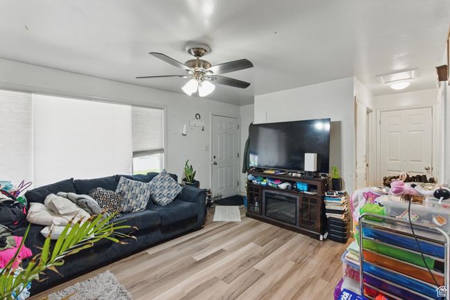 Living area featuring light wood-type flooring and a ceiling fan | Image 18