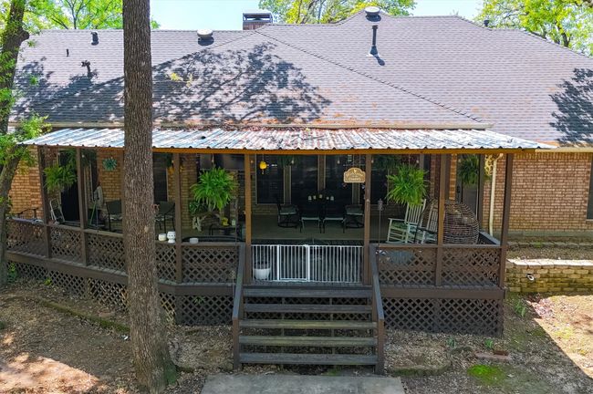 Rear view of property featuring roof with shingles, a chimney, and a deck | Image 31