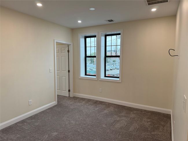 Unfurnished room featuring dark carpet and recessed lighting | Image 5