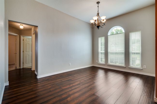 Unfurnished room featuring dark wood-type flooring and a chandelier | Image 15