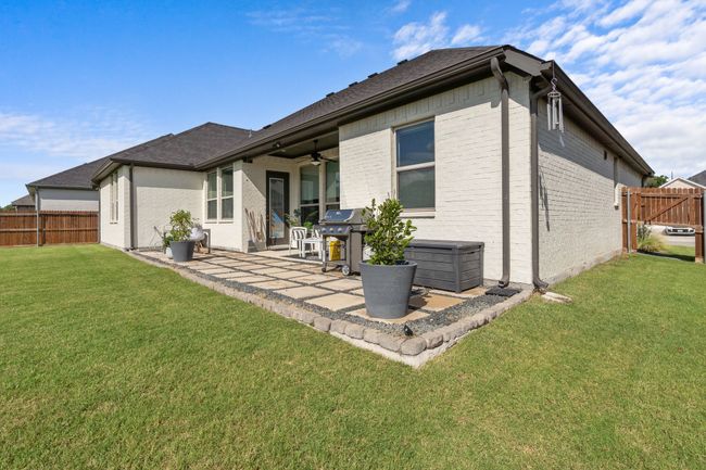 Rear view of property with ceiling fan, a patio, brick siding, and roof with shingles | Image 28